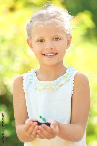 Cute girl holding green pla...