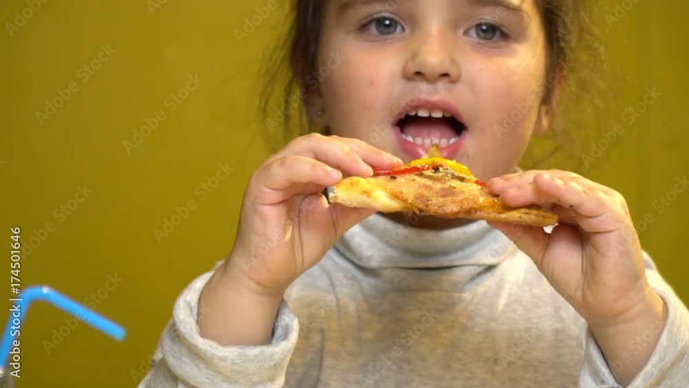 Little child girl portrait funny eat slice of pizza with sauce and cheese, bacon, chicken, mushrooms champignons, peppers and tomatoes. Little child girl portrait funny eat slice of pizza with sauce and cheese, bacon, chicken, mushrooms champignons, peppers and tomatoes.