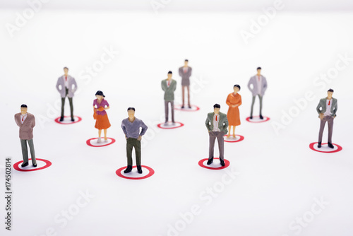 Miniature business people in conection scheme over white backdrop or background.