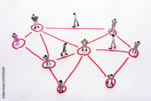 Miniature business people in conection scheme over white backdrop or background.