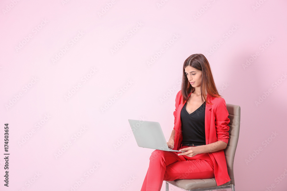 Young woman with laptop on color background Young woman with laptop on color background