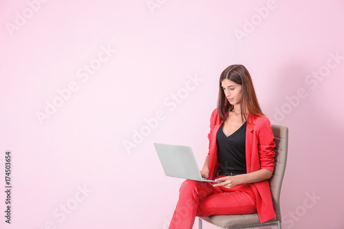 Young woman with laptop on ...