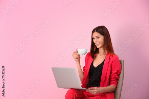Young woman with laptop on ...