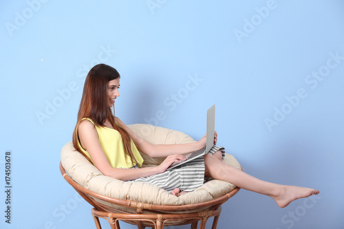 Young woman with laptop on ...