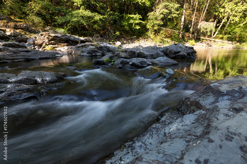 Water spring running down the smooth rocks in a beautiful canyon. Taken in Sooke Potholes Provincial Park near Victoria, Vancouver Island, BC, Canada.
Water spring running down the smooth rocks in a beautiful canyon. Taken in Sooke Potholes Provincial Park near Victoria, Vancouver Island, BC, Canada.