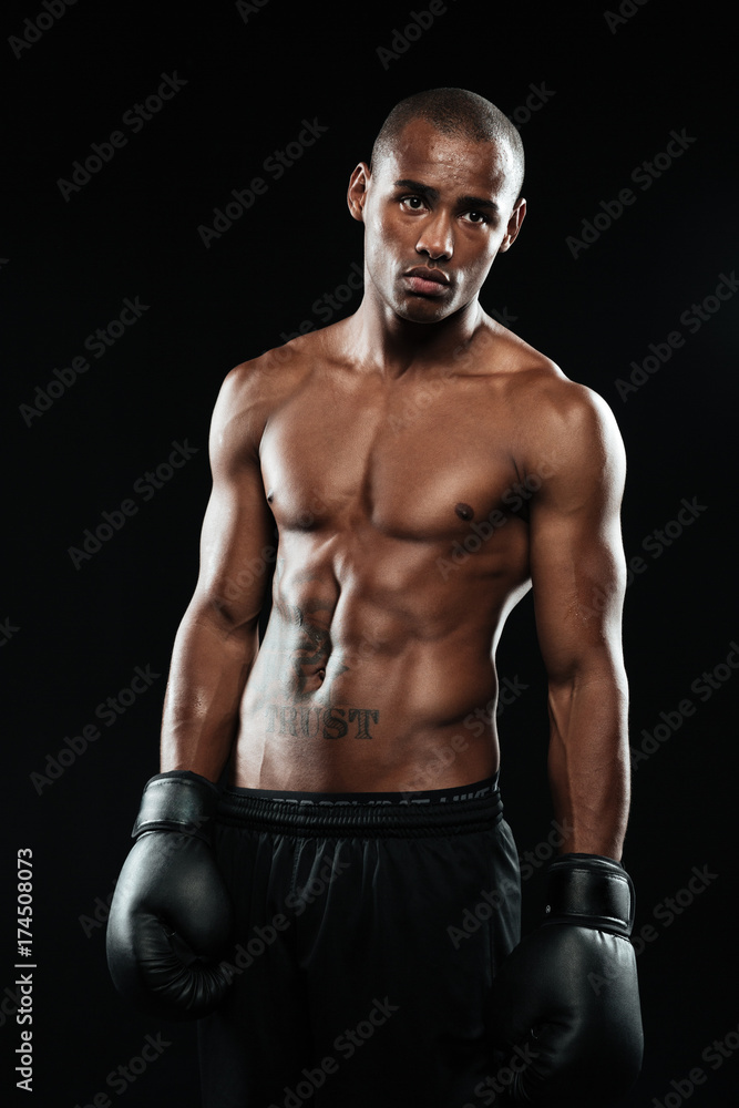 Portrait of young handsome afroamerican boxer in gloves