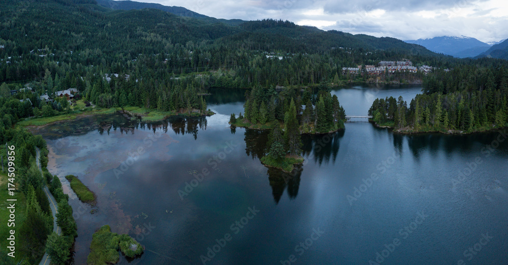 Aerial Panoramic view of Alpha Lake during a vibrant sunrise. Taken in Whistler, British Columbia, Canada. Aerial Panoramic view of Alpha Lake during a vibrant sunrise. Taken in Whistler, British Columbia, Canada.