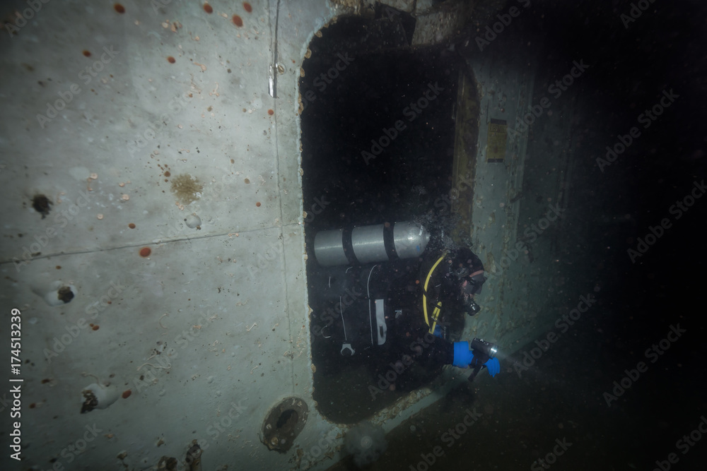 Underwater picture of a scuba diver exploring a sunken wreck ship. Taken in Howe Sound, near Vancouver, British Columbia, Canada.
