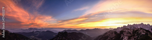 Mountain landscape at sunset in Julian Alps. Amazing view on colorful clouds and layered mountains. photo