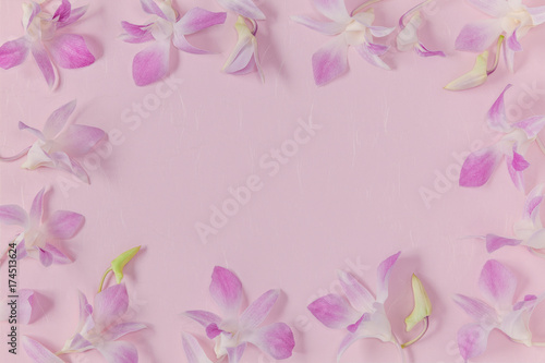 Flower frame made from orchid, pink background.