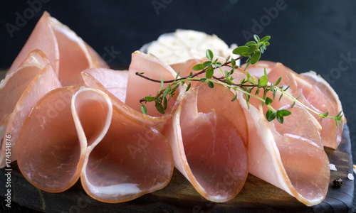 Thinly sliced ham on a wooden Board.