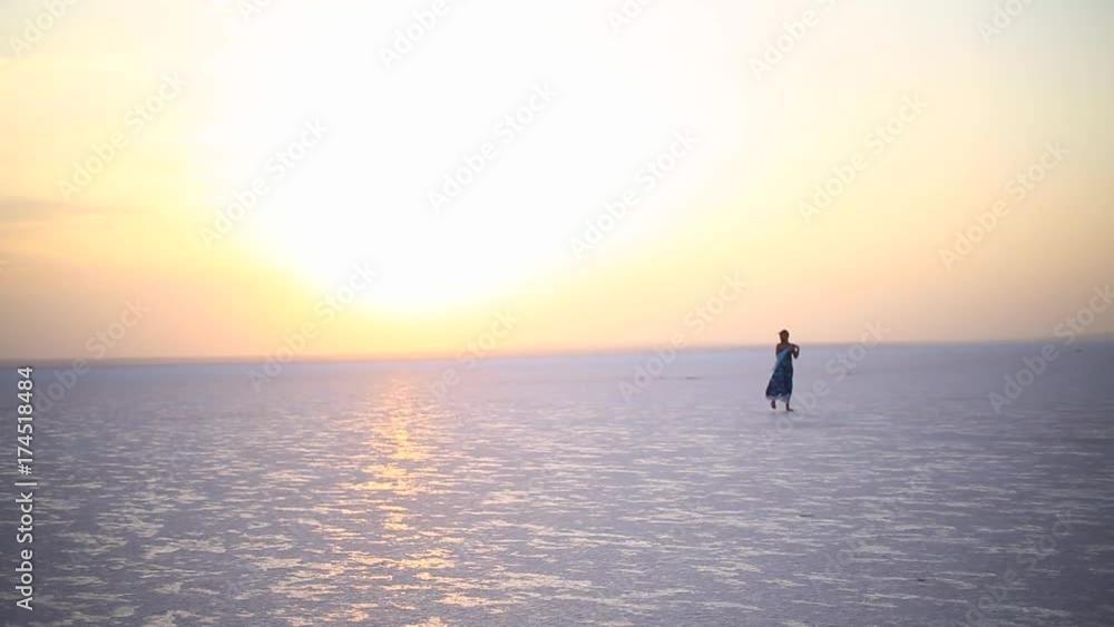 A cheerful girl at sunset at Lake Salt. A cheerful girl at sunset at Lake Salt.