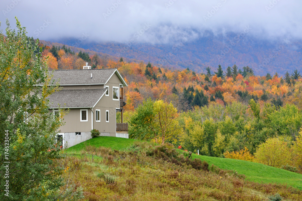 Vermont Fall Foliage in a cloudy day, Mount Mansfield in the background, Vermont, USA.