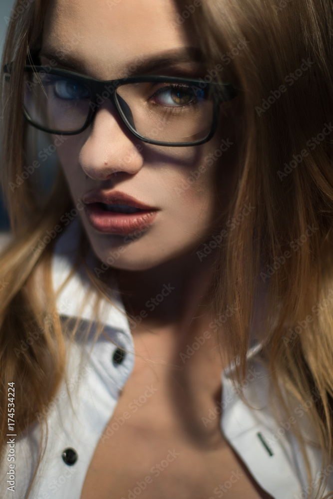 close up portrait of beautiful blonde secretary in glasses