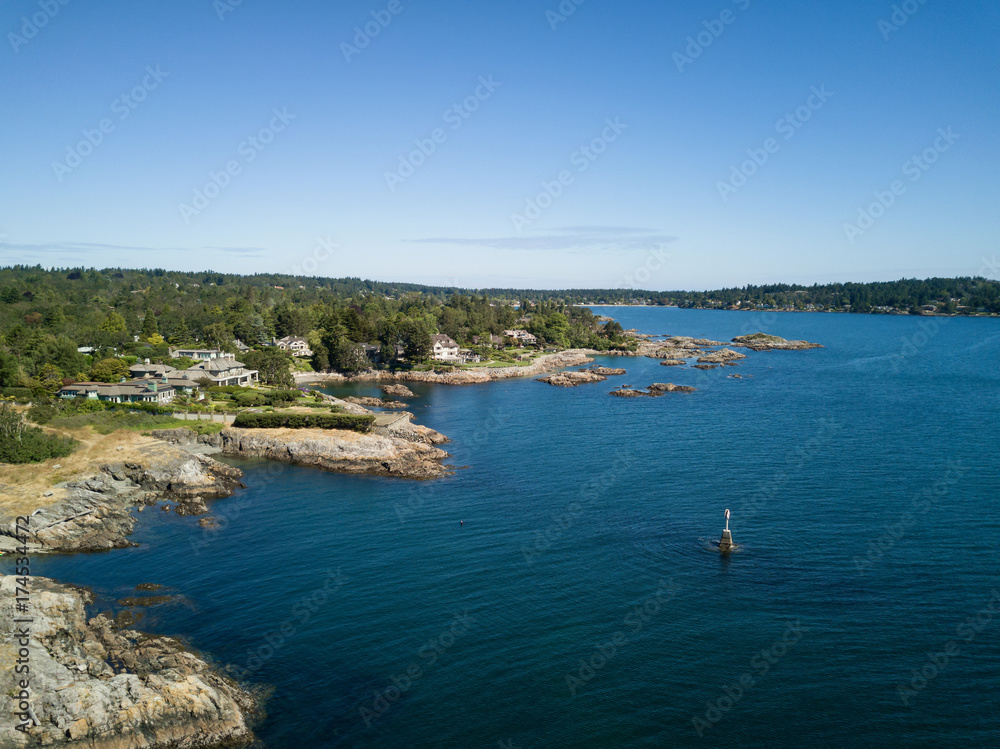 Aerial landscape view of a beautiful rocky shore on Pacific Coast. Taken in Uplands Park, Victoria, Vancouver Island, British Columbia, Canada. Aerial landscape view of a beautiful rocky shore on Pacific Coast. Taken in Uplands Park, Victoria, Vancouver Island, British Columbia, Canada.