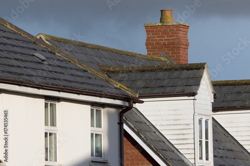 Принти на полотні Modern town house roof with slate tiles, chimney and white dormer window