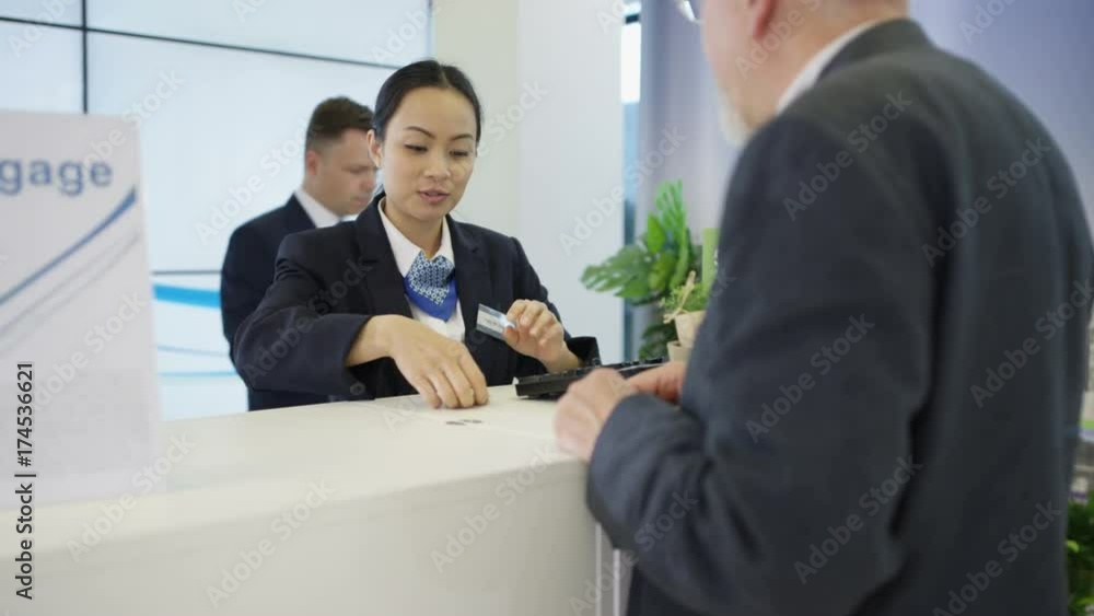 Bank worker at service desk assists customer with a cash withdrawal Bank worker at service desk assists customer with a cash withdrawal