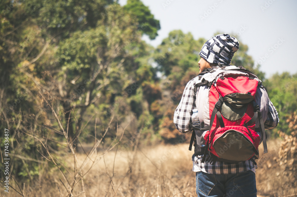 Traveler looking to map on the way in forest Traveler looking to map on the way in forest