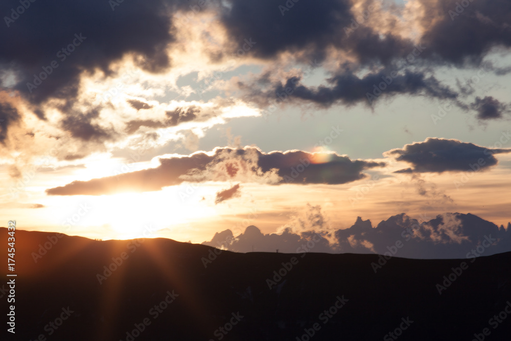 Sun shining alongside dolomitic ridges, Veneto, Italy