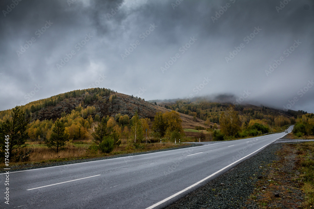 Fototapeta premium Road in the mountains with low clouds