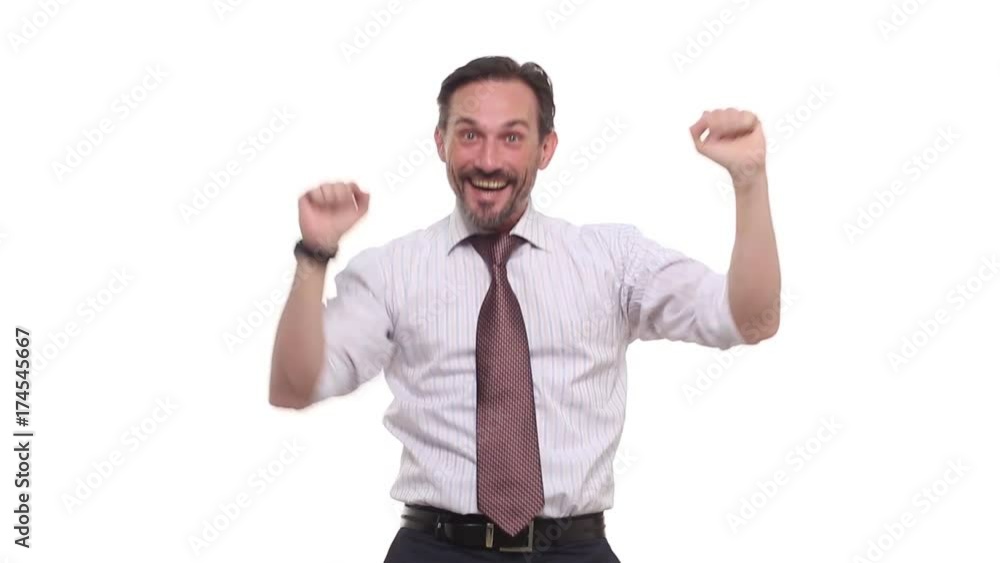 Handsome businessman cheering his success raising both fists in the air as he smiles with satisfaction over white background with copy space. Excitement and amazement in business. Handsome businessman cheering his success raising both fists in the air as he smiles with satisfaction over white background with copy space. Excitement and amazement in business.