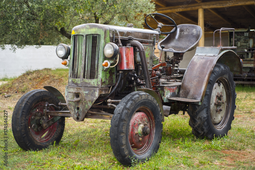 Retro tractor in green summer park. Retro tractor in green summer park.