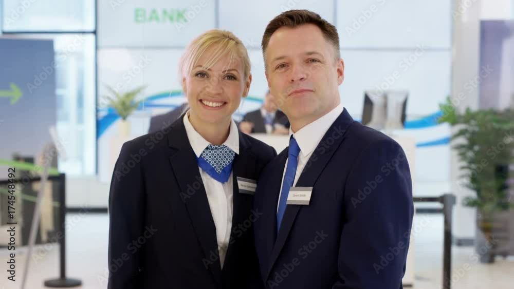 Portrait of friendly smiling customer service staff at work in bank Portrait of friendly smiling customer service staff at work in bank