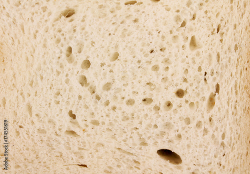 Wallpaper Mural Macro photo. a piece of toast bread close-up, isolated on a wooden background. Maximum approximation. Fibers of bread close up Torontodigital.ca