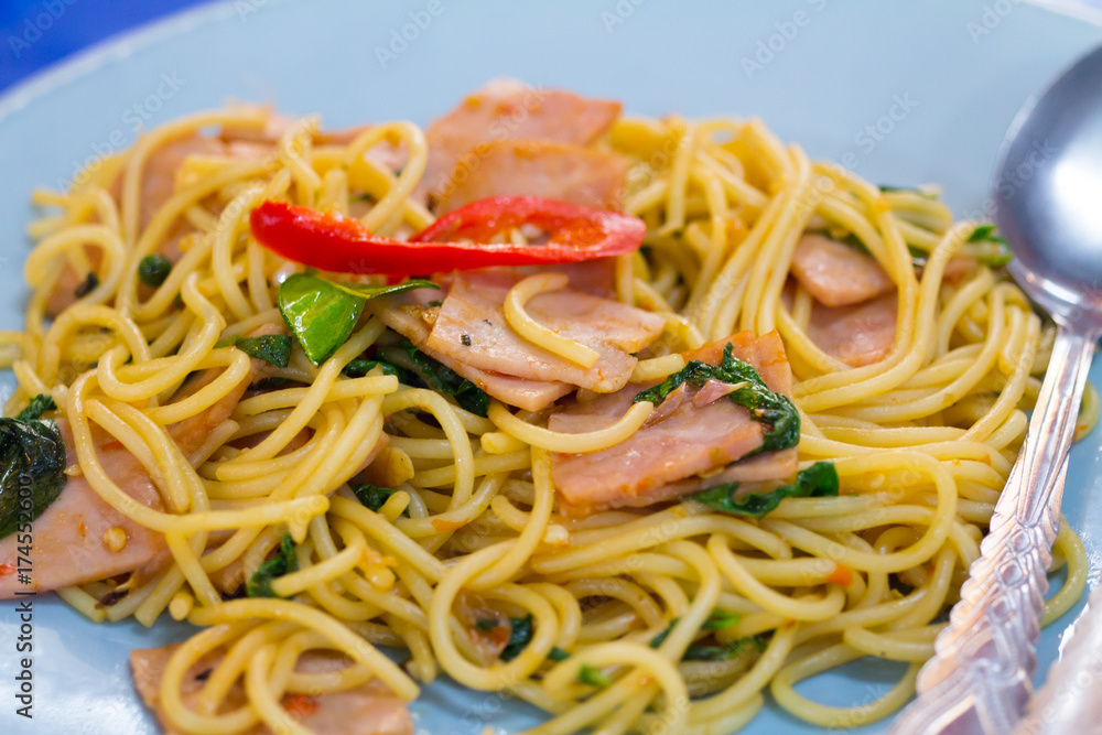 fusion food, spaghetti with fried crispy bacon ,sausage and basil leave, hot and spicy food, international cuisine fusion food, spaghetti with fried crispy bacon ,sausage and basil leave, hot and spicy food, international cuisine
