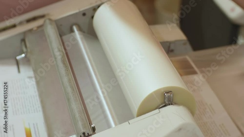 Сaucasian male working with roll laminator