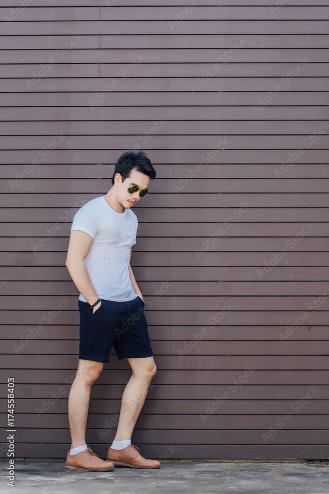 Portrait photo of young man posing against wooden background,fashion style. Portrait photo of young man posing against wooden background,fashion style.