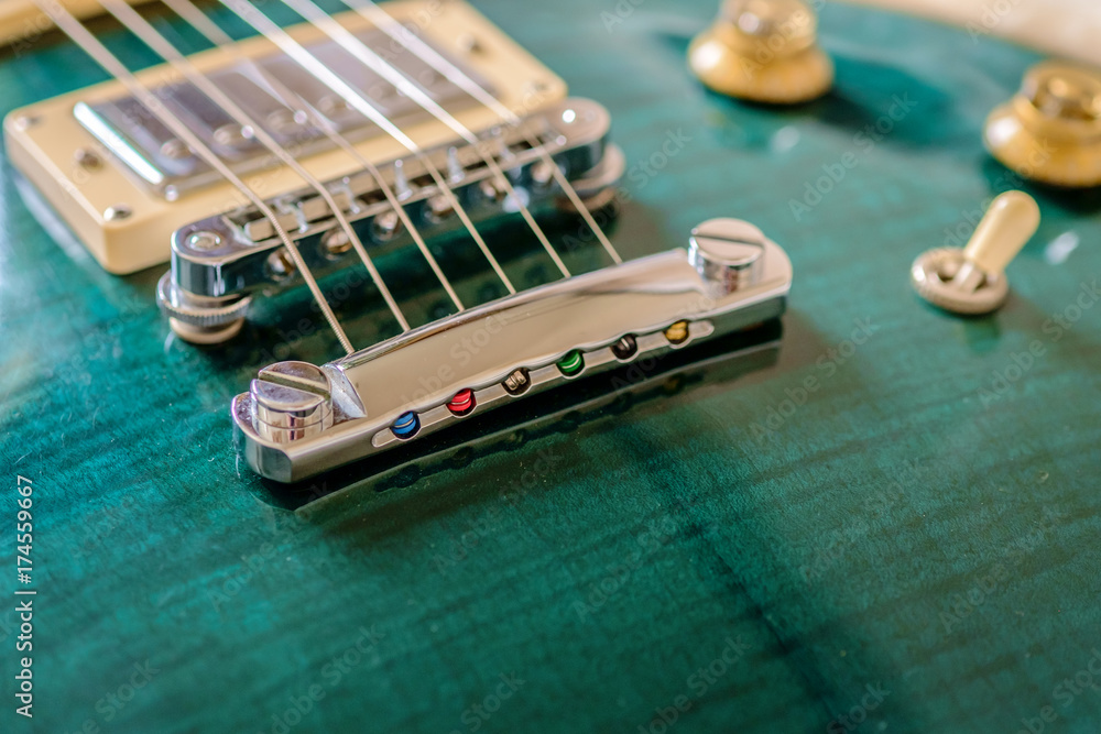 Jalapeno green electric guitar maple top body close up view with bridge, tone knobs and pickup switch Jalapeno green electric guitar maple top body close up view with bridge, tone knobs and pickup switch