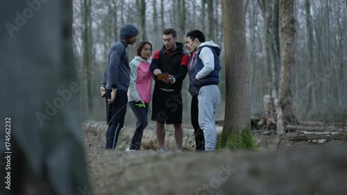 Wallpaper Mural Cheerful group of runners in the woods using computer tablet for navigation. Torontodigital.ca