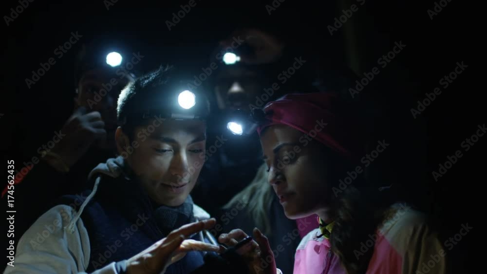 Group hiking in the woods at night pose to take selfie with smartphone. Group hiking in the woods at night pose to take selfie with smartphone.