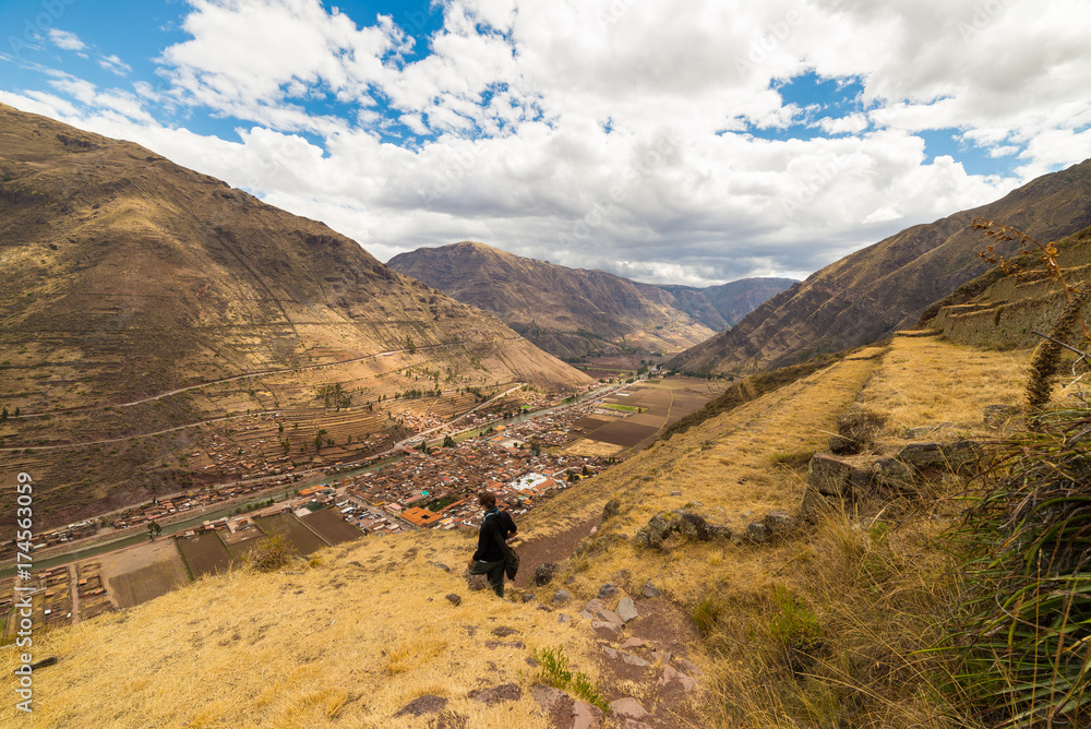 Tourist exploring the Inca Trails and the majestic terraces of Pisac, Sacred Valley, major travel destination in Cusco region, Peru. Vacations and adventures in South America.