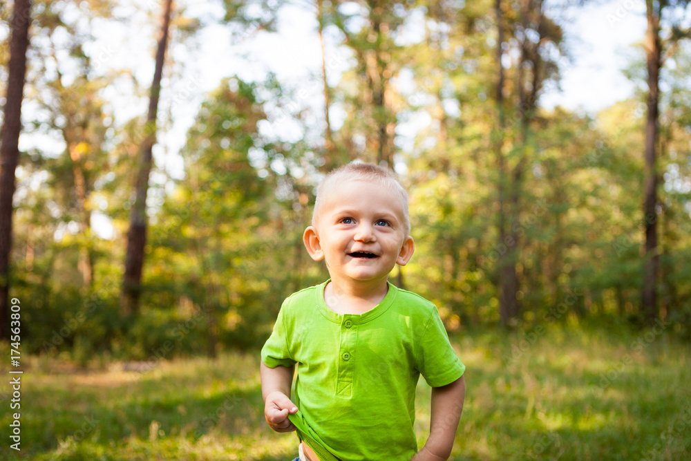 Cute little boy smiling in park, with copy space Cute little boy smiling in park, with copy space
