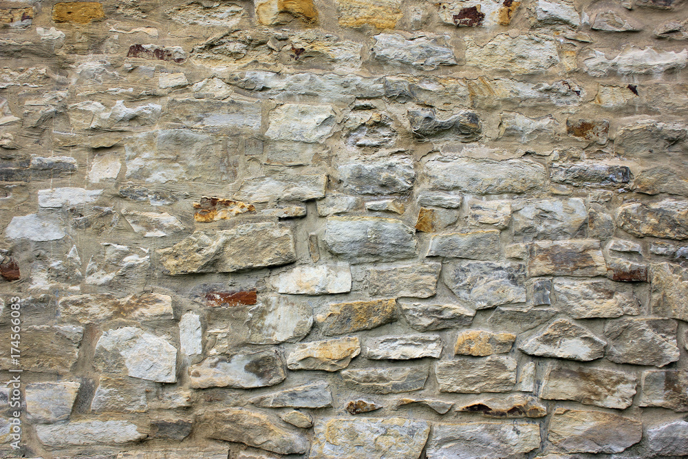 Old beige stone wall background texture close up. Old beige stone wall background texture close up.