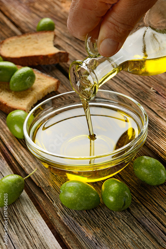 pour olive oil into glass bowl