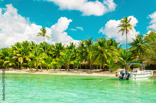 Amazing exotic coast of Dominican Republic with high palms, colorful boats