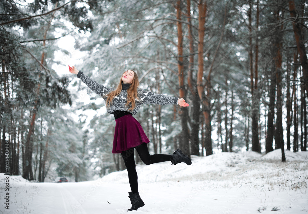 Winter portrait of young beautiful brunette woman wearing sweater. Snowing winter beauty fashion concept.
