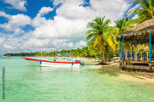 Amazing Caribbean coast with moored motorboat, Dominican Republic photo