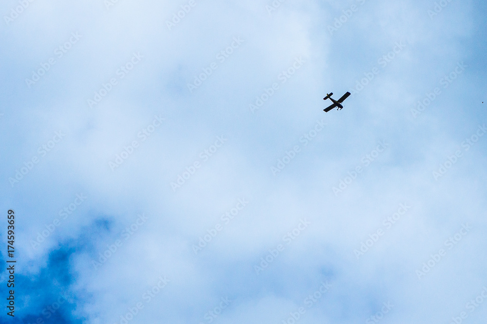 Cloudy sky. The plane flies into the distance.