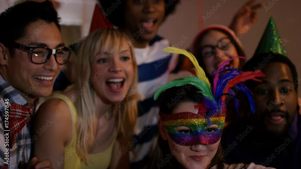 Nerdy friends having fun at house party pose to take a selfie with smartphone Nerdy friends having fun at house party pose to take a selfie with smartphone