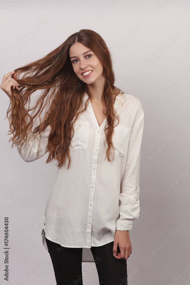 Portrait of Beautiful Smiling Girl With Healthy Curly Long Hair. Hairdressing Concept. Portrait of Beautiful Smiling Girl With Healthy Curly Long Hair. Hairdressing Concept.