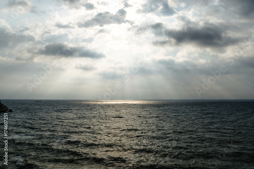 Dramatic Light Rays Coming From The Overcast Sky Over Stormy Sea