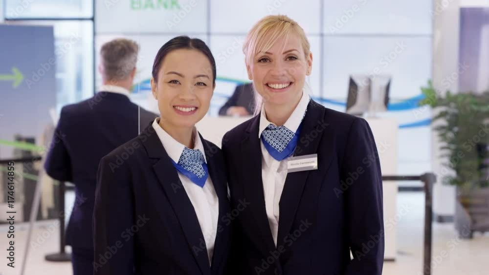 Portrait of friendly smiling customer service staff at work in bank Portrait of friendly smiling customer service staff at work in bank