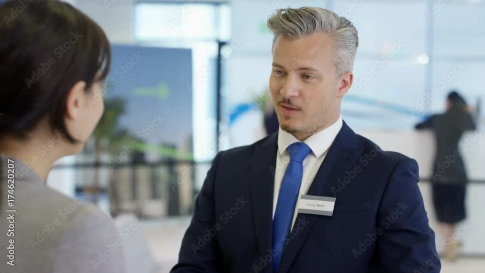 Friendly bank workers talking to customers & offering financial advice Friendly bank workers talking to customers & offering financial advice