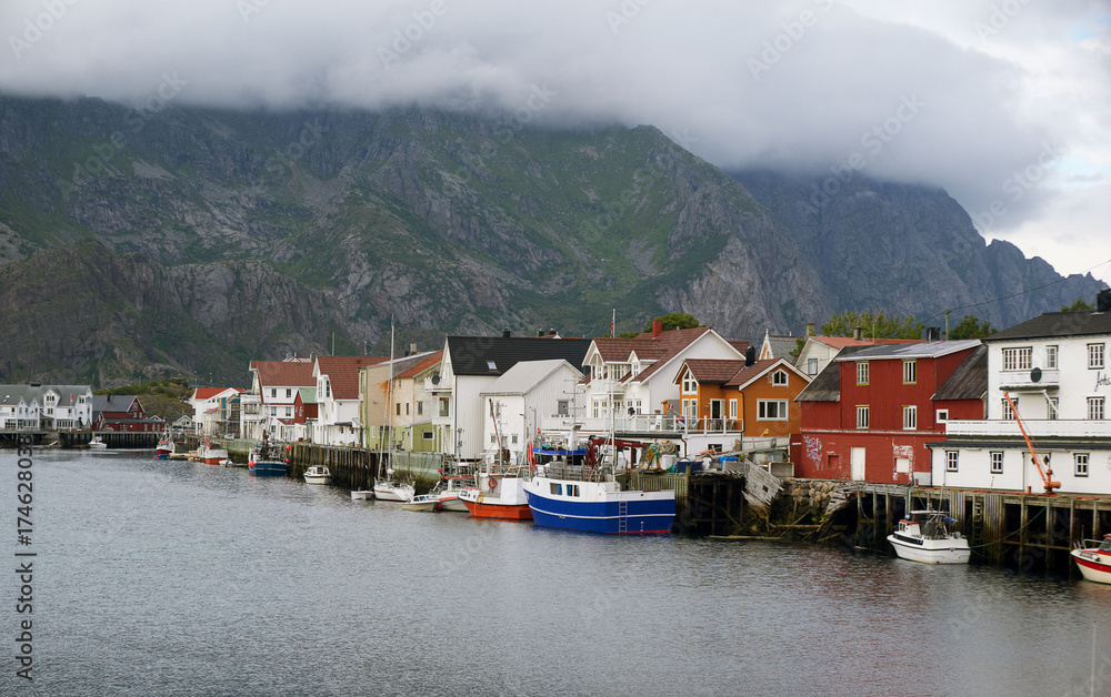 Houses at the water with boats and mountains on background, Lofotens, Norway