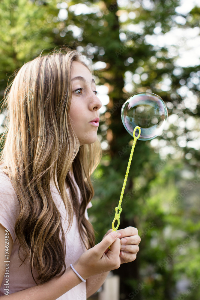 Beautiful teenage girl blowing bubbles Beautiful teenage girl blowing bubbles