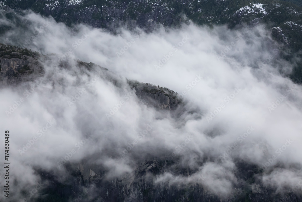 Aerial View of Chief Mountain Covered in Clouds. Taken in Squamish, British Columbia, Canada, during a cloudy winter morning.